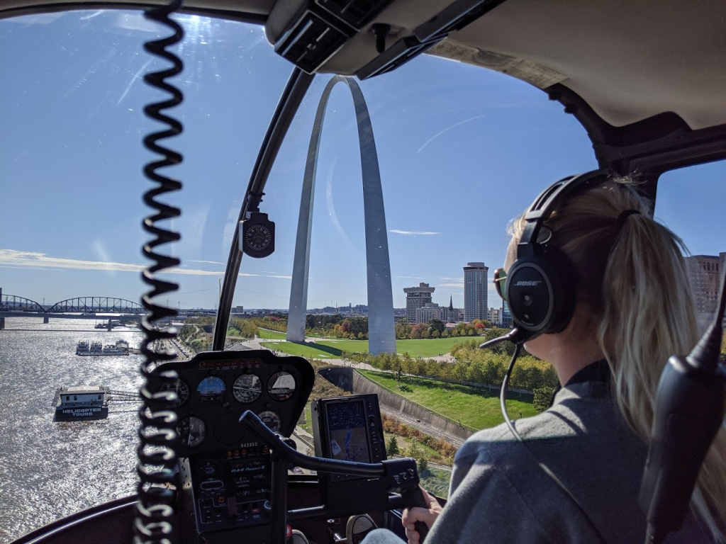 View of inside of helicopter with Gateway Arch beyond