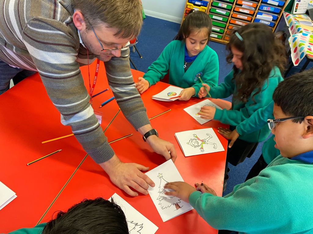 Box UK team member showing school children how to create light-up cards